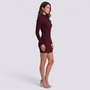 Essyro burgundy ribbed mini sheath dress with high neck and long sleeves worn by a woman in profile