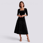 Essyro black midi velvet dress with floral jacquard pattern, square neckline, and A-line skirt worn by a model.