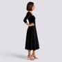Essyro black velvet midi dress with floral jacquard pattern, square neckline, and A-line skirt on a model