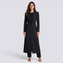 Mujer con blazer largo negro entallado con hebilla, vista frontal
