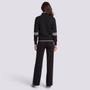 Conjunto mujer media cremallera y pantalón ancho negro, vista trasera