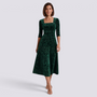 Essyro midi dress in green velvet with floral jacquard pattern, square neckline, and A-line skirt on a model
