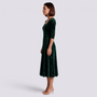 Essyro midi dress in dark green velvet with floral jacquard pattern, square neckline, and A-line skirt on a model.