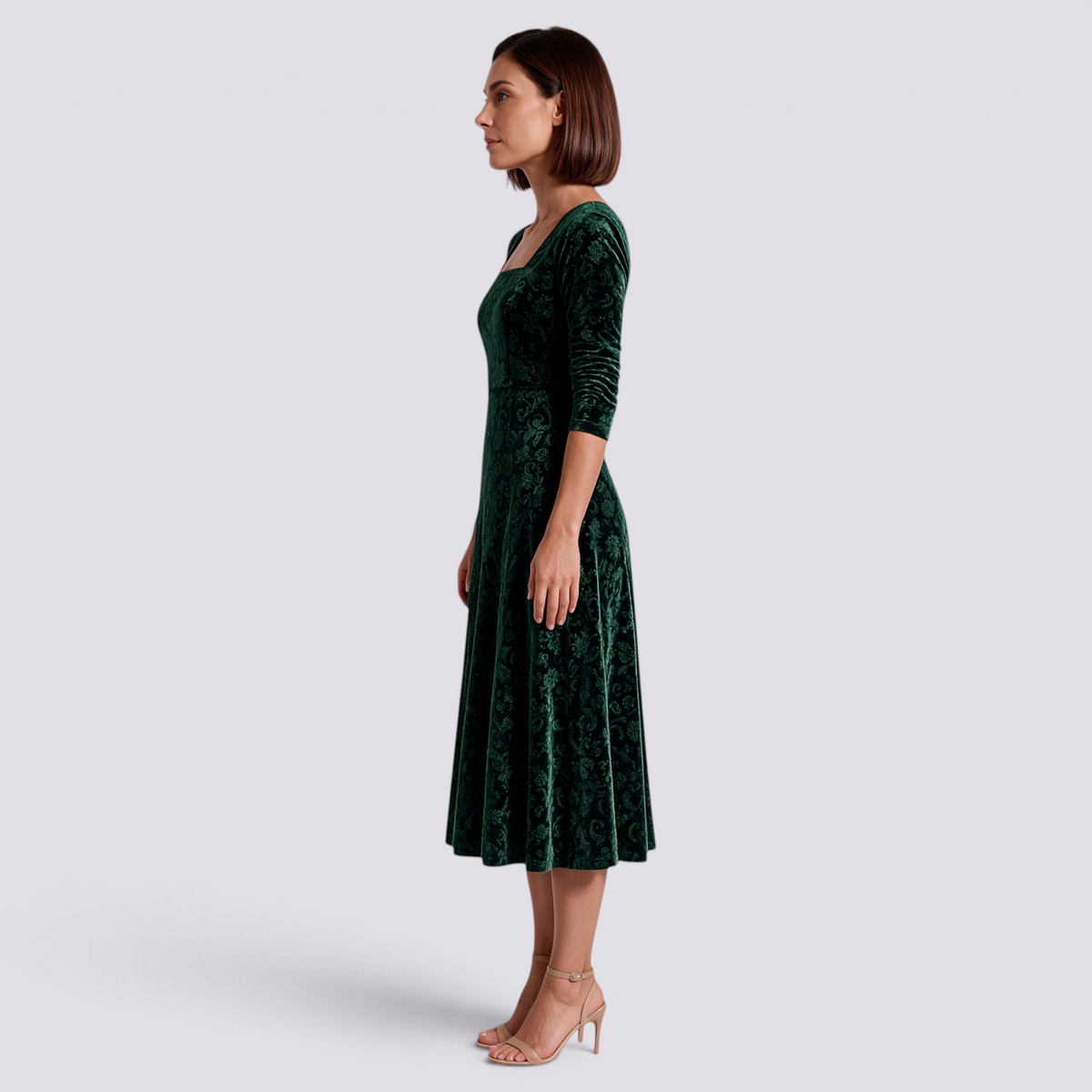 Essyro midi dress in dark green velvet with floral jacquard pattern, square neckline, and A-line skirt on a model.