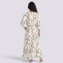 Essyro two-piece set with a cream top and maxi skirt featuring a black abstract line art print and dolman sleeves.