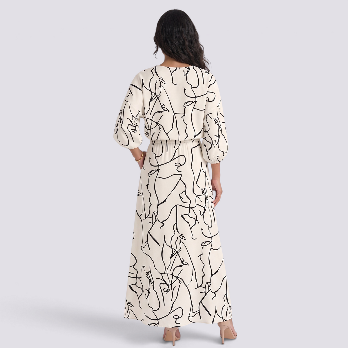 Essyro two-piece set with a cream top and maxi skirt featuring a black abstract line art print and dolman sleeves.