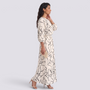 Essyro two-piece set featuring a cream top and maxi skirt with a black abstract line print, worn by a model.