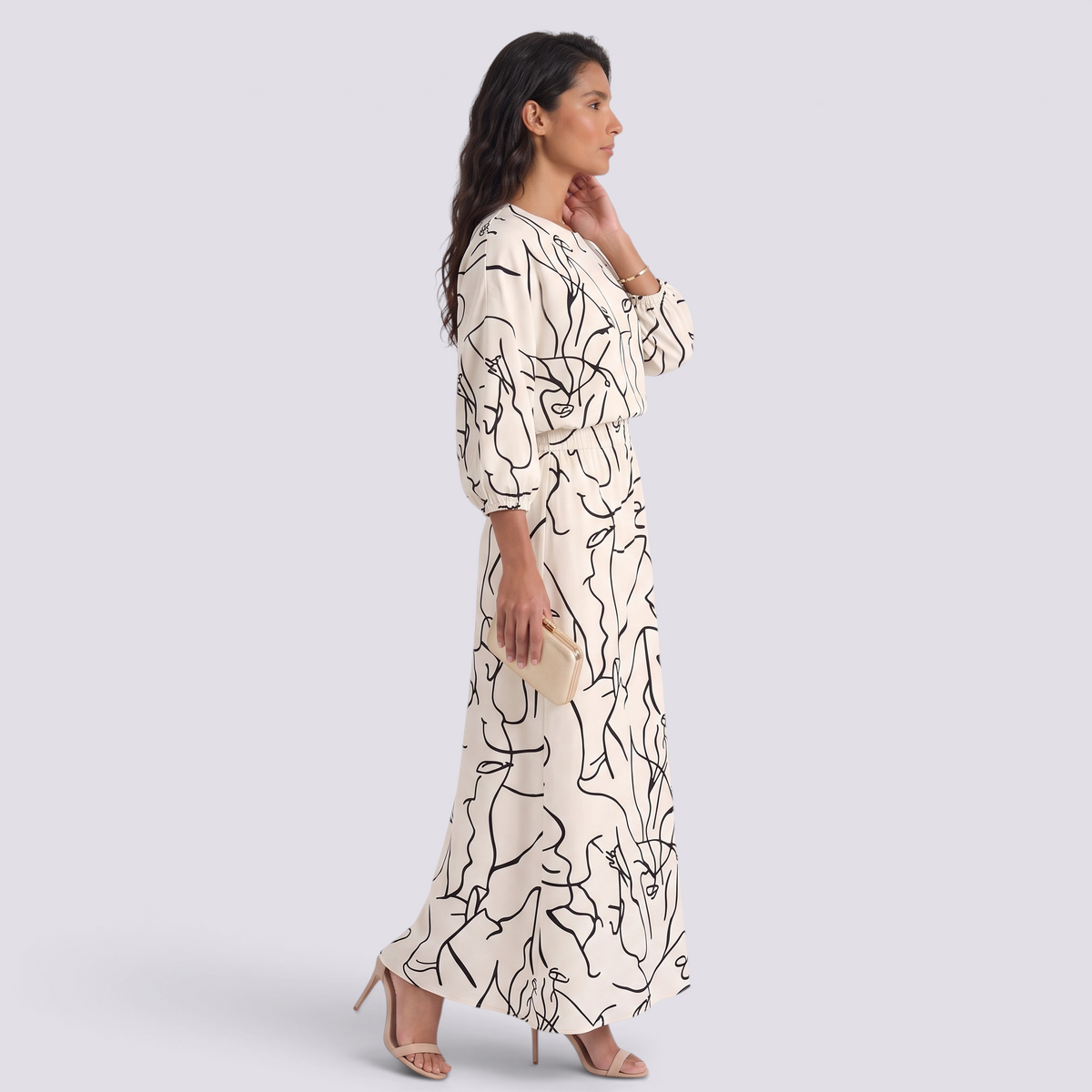 Essyro two-piece set featuring a cream top and maxi skirt with a black abstract line print, worn by a model.