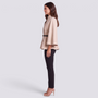Essyro beige batwing sleeve cape with mandarin collar and thin black belt worn by a model in profile view