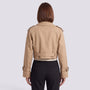 Back view of an Essyro beige cropped windbreaker jacket with epaulettes and belted cuffs worn over black trousers