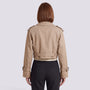 Back view of an Essyro beige cropped windbreaker jacket with epaulettes and belted cuffs on a woman
