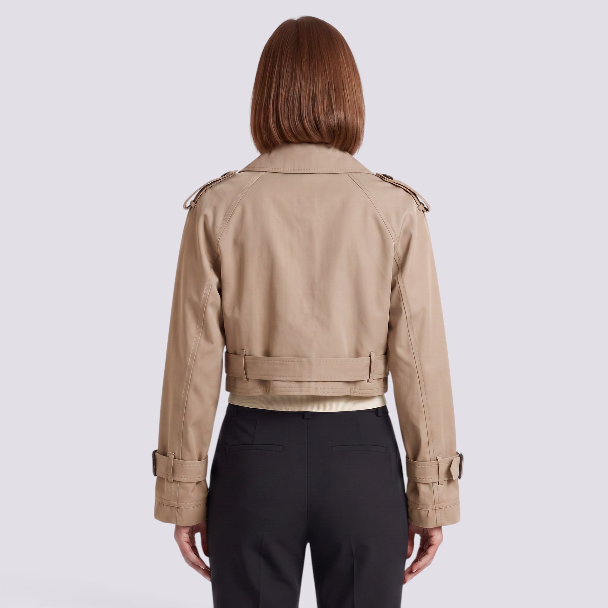 Back view of an Essyro beige cropped windbreaker jacket with epaulettes and belted cuffs on a woman