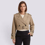 Essyro beige cropped windbreaker jacket with double-breasted button detail and belted waist worn by a woman