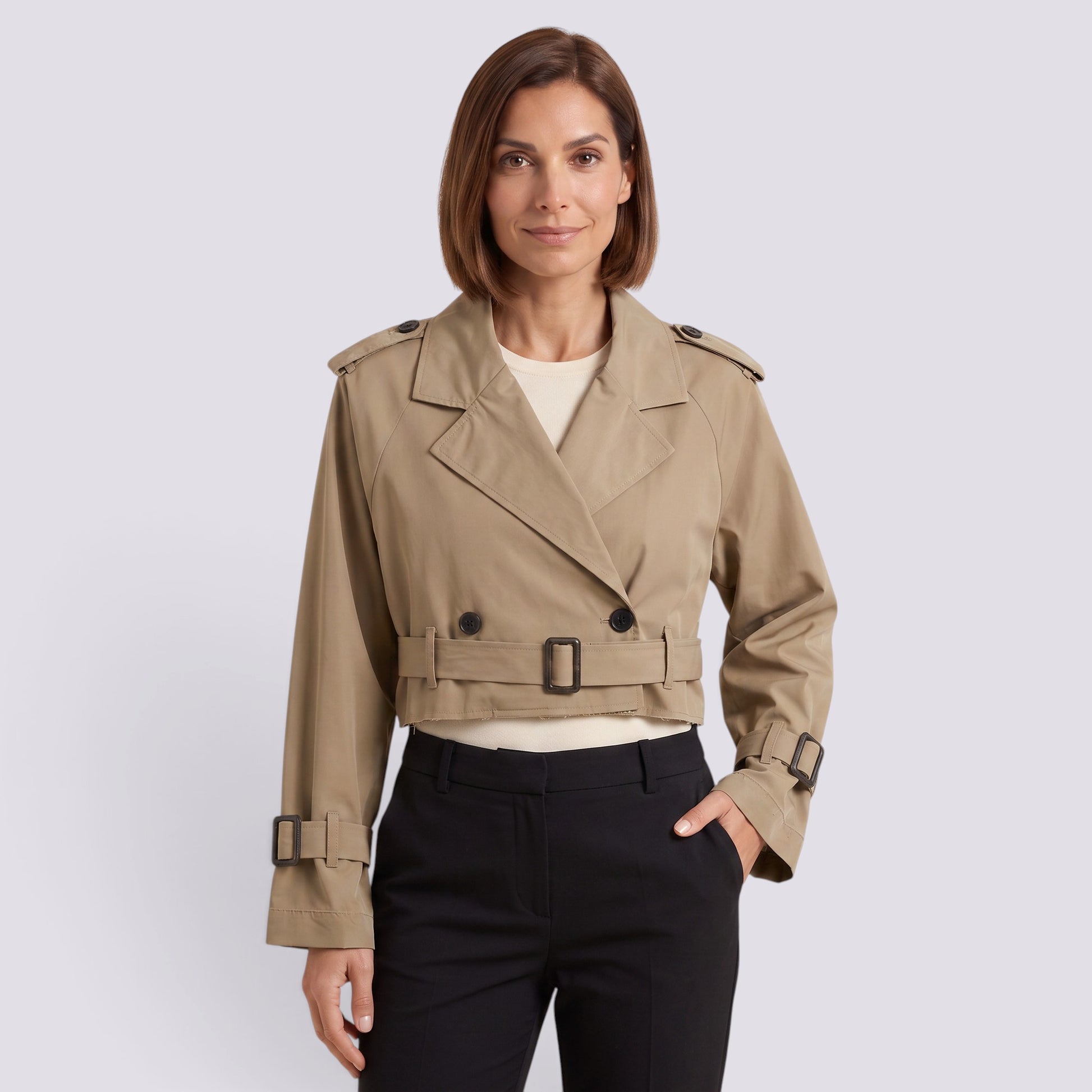 Essyro beige cropped windbreaker jacket with double-breasted button detail and belted waist worn by a woman