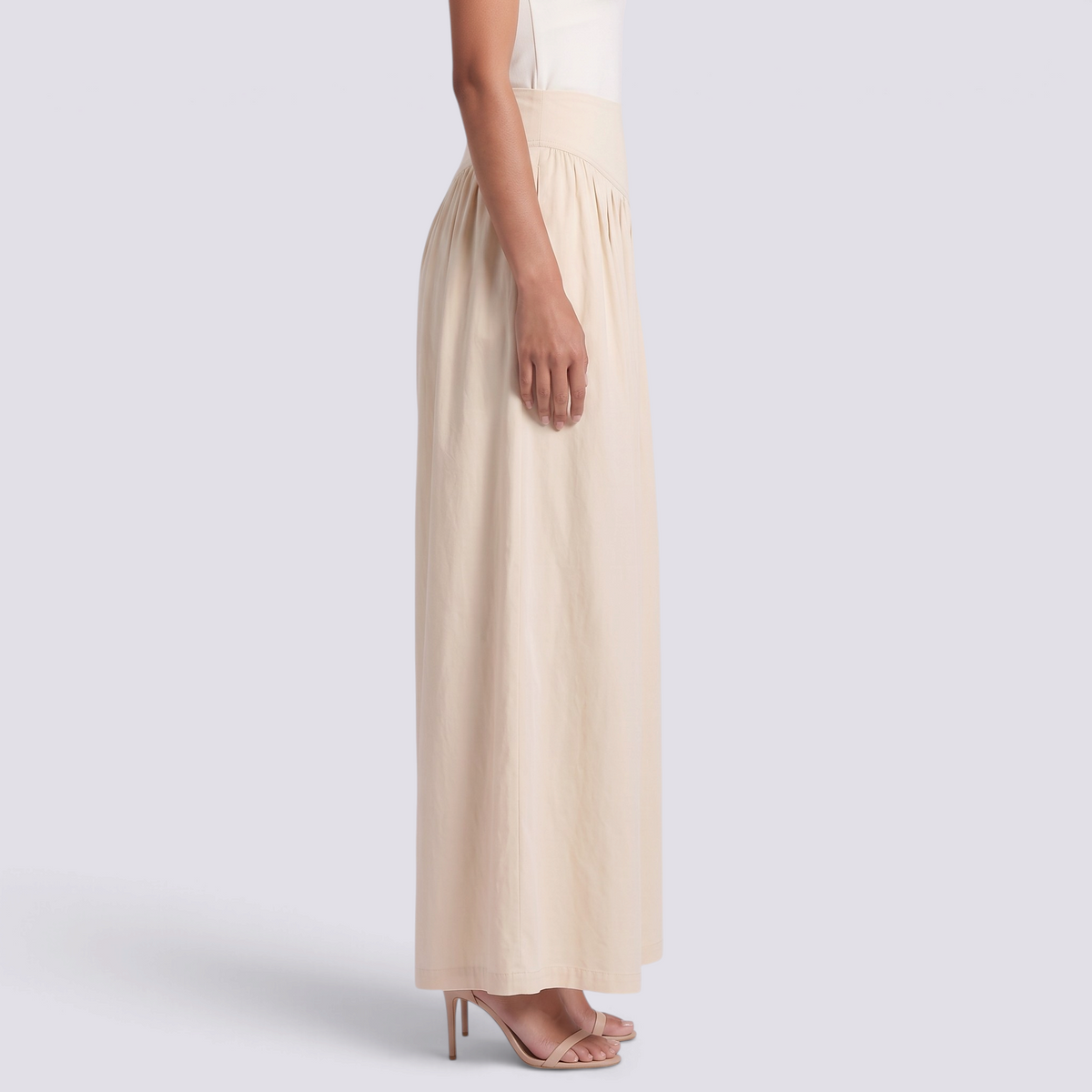 Essyro high-waisted beige palazzo trousers with a V-shaped waistband, gathered details, and wide-leg floor-length fit.
