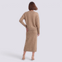 Essyro beige two-piece knit set featuring a loose crew neck sweater and a midi skirt with ribbed hem on a model