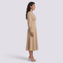 Essyro beige midi dress with V-neck, puffed sleeves, and buttoned waist worn by a model in profile view