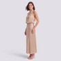 Essyro beige satin halter neck maxi dress with draped bodice and open back worn by a woman in studio