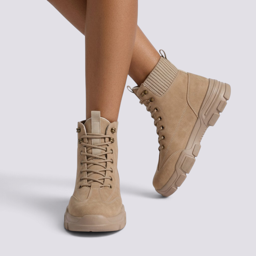 Essyro beige suede military-style ankle boots with ribbed knit sock collar, lace-up front, and chunky rubber sole.