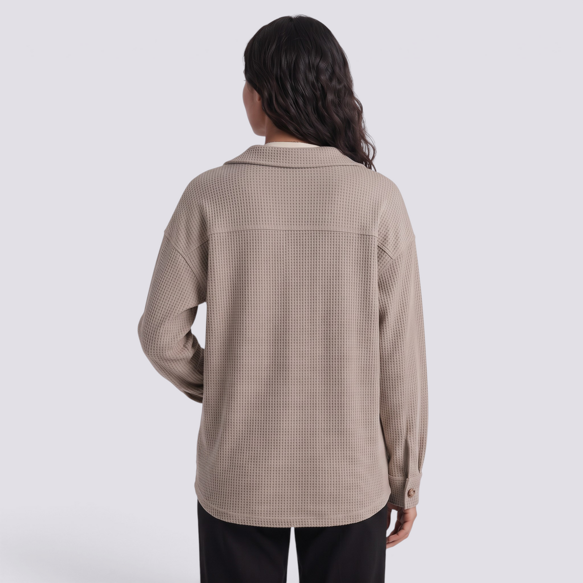 Back view of a woman wearing an Essyro beige waffle-knit shirt jacket with long sleeves and a relaxed fit.