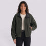 Essyro bicolor jacket in dark green with a black faux leather collar worn by a smiling woman