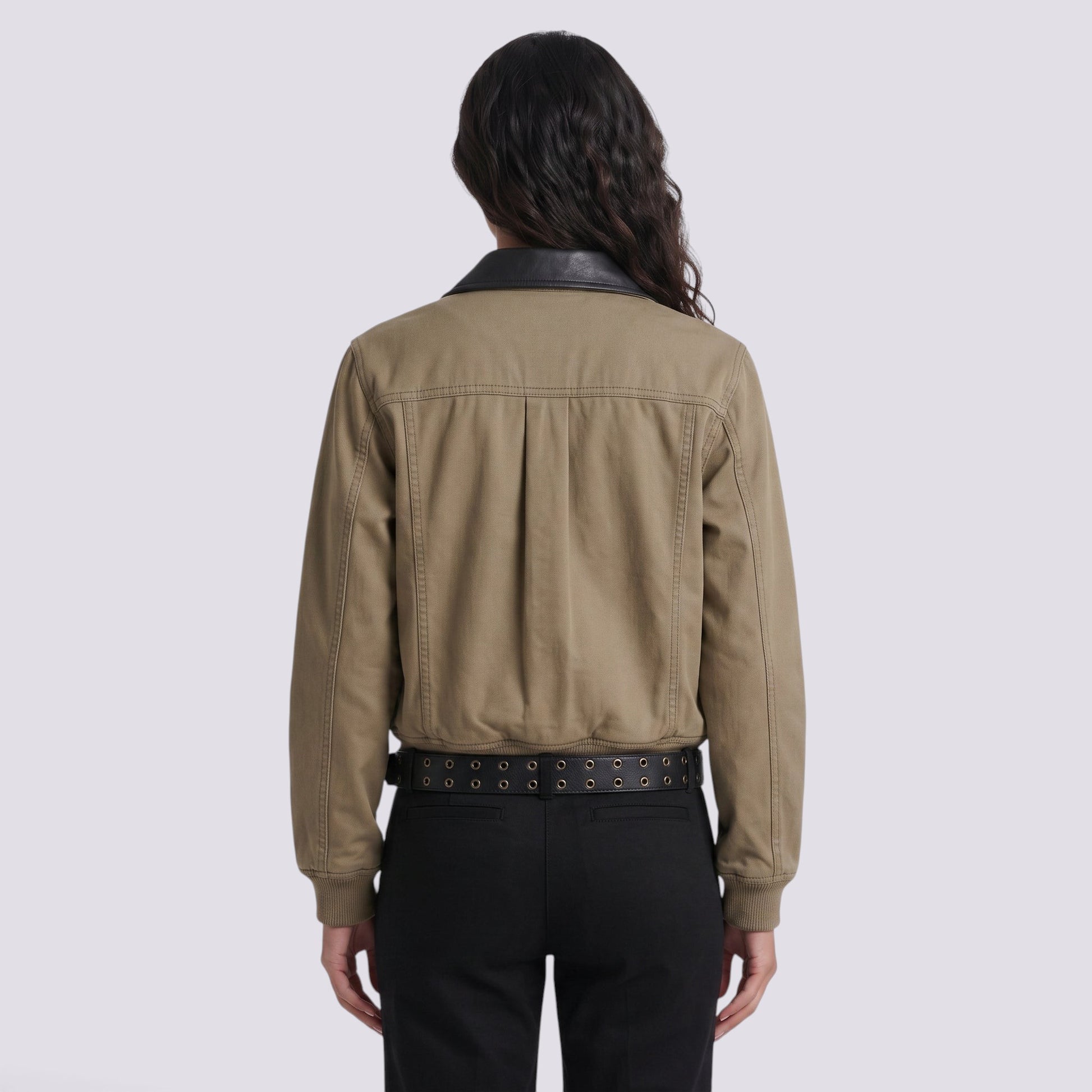Back view of an Essyro bicolor jacket in olive green with a black faux leather collar, worn with black trousers.
