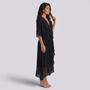 Essyro black maxi dress with V-neck, batwing sleeves, and asymmetric hem worn by a model in a studio setting.