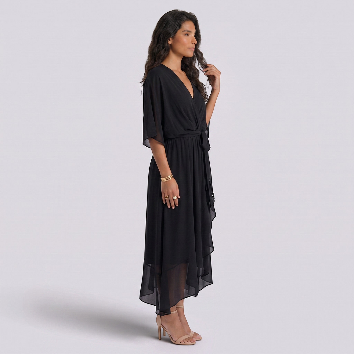 Essyro black maxi dress with V-neck, batwing sleeves, and asymmetric hem worn by a model in a studio setting.