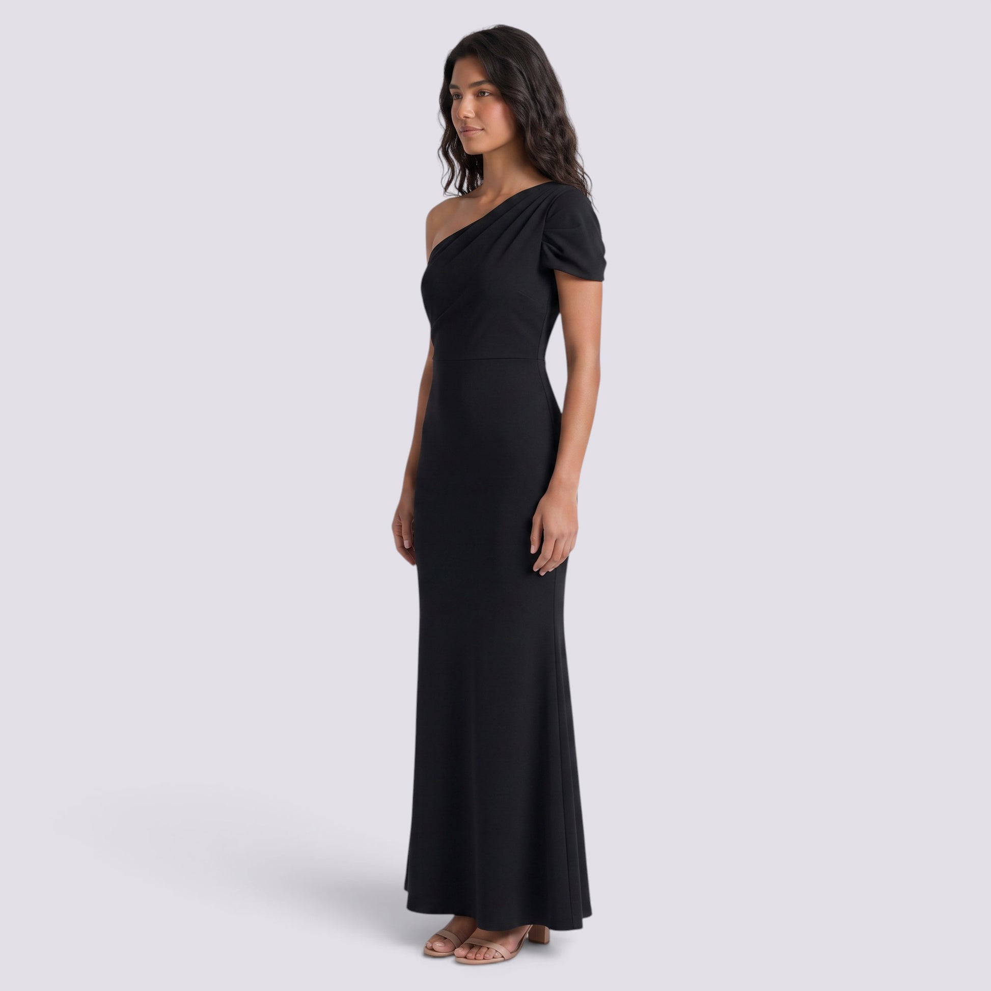 Essyro black floor-length mermaid gown with an asymmetric one-shoulder neckline and draped sleeve on a model