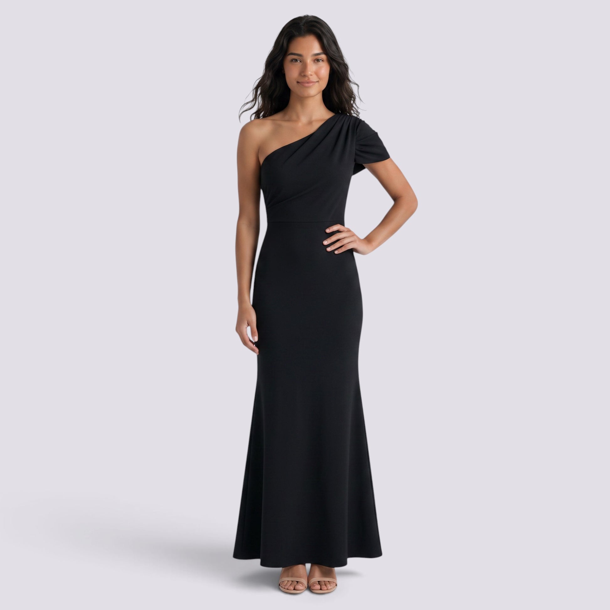 Essyro black floor-length mermaid gown with an asymmetric one-shoulder neckline and draped sleeve detail.