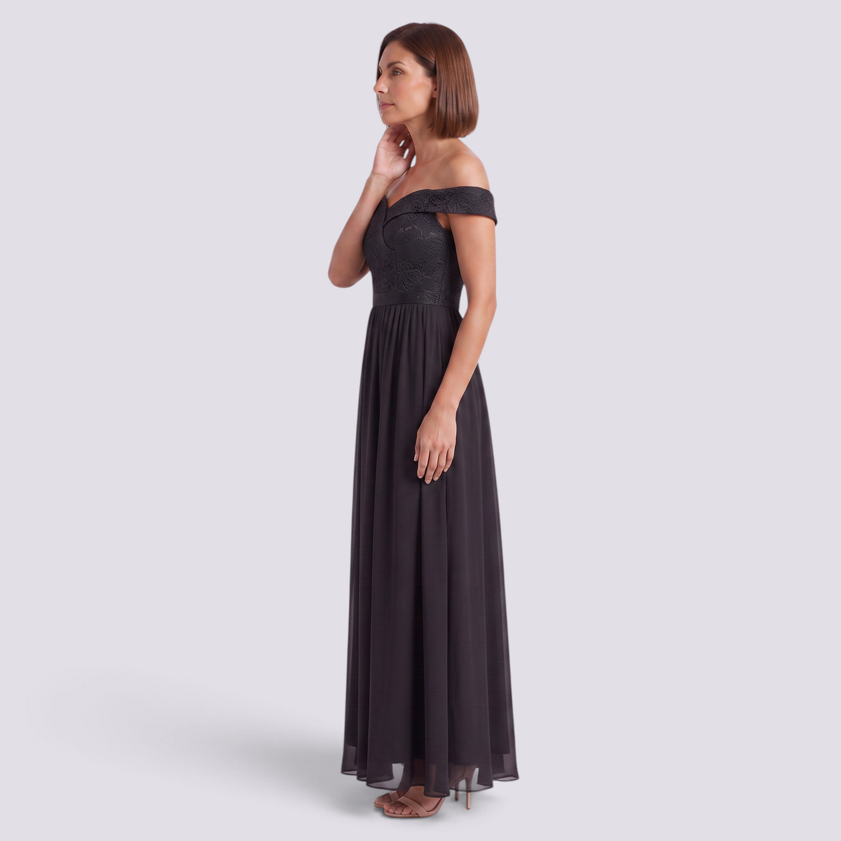 Essyro elegant black floor-length gown with a bardot neckline, lace bodice, and flowing A-line skirt on a model.