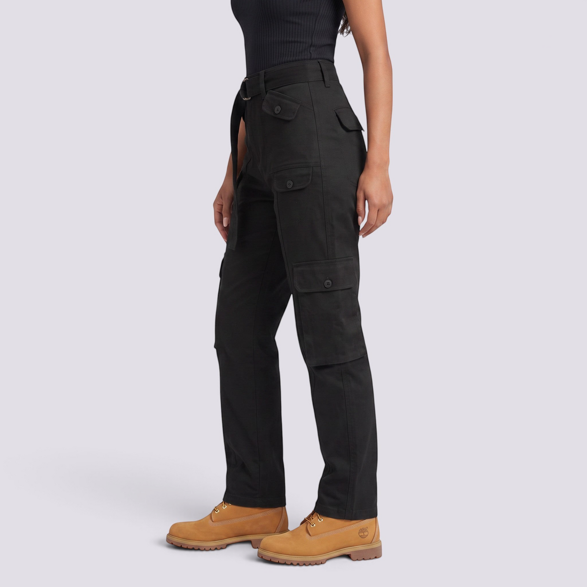 Essyro black cargo jeans with utility pockets and a mid-rise straight fit worn by a model in a studio setting.