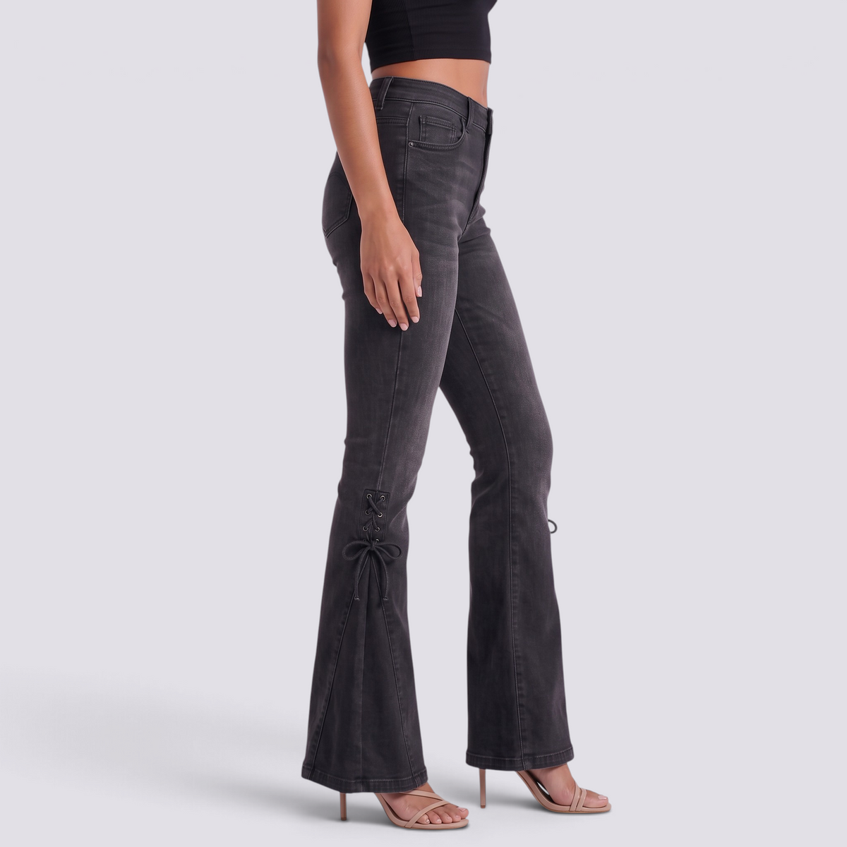 Essyro mid-rise flare jeans in washed black denim featuring side lace-up detailing and a flared leg silhouette.