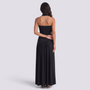 Essyro black floor-length party dress with halter neck, open back, and draped asymmetrical skirt, back view