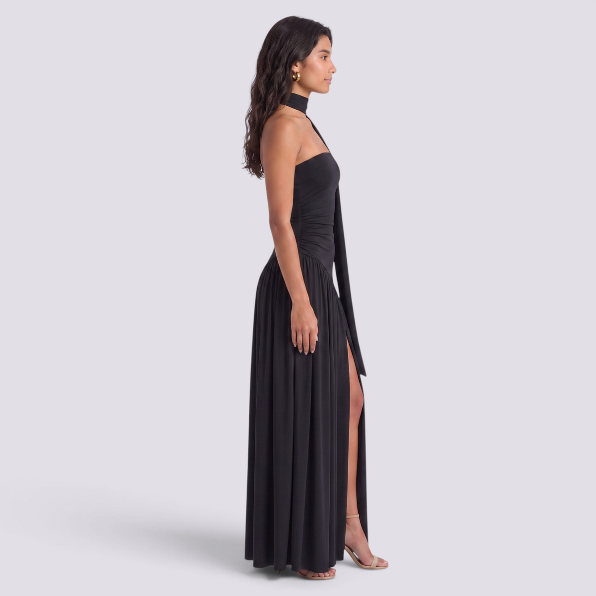 Essyro black floor-length evening dress with halter neck, draped asymmetric skirt, and side slit on a model