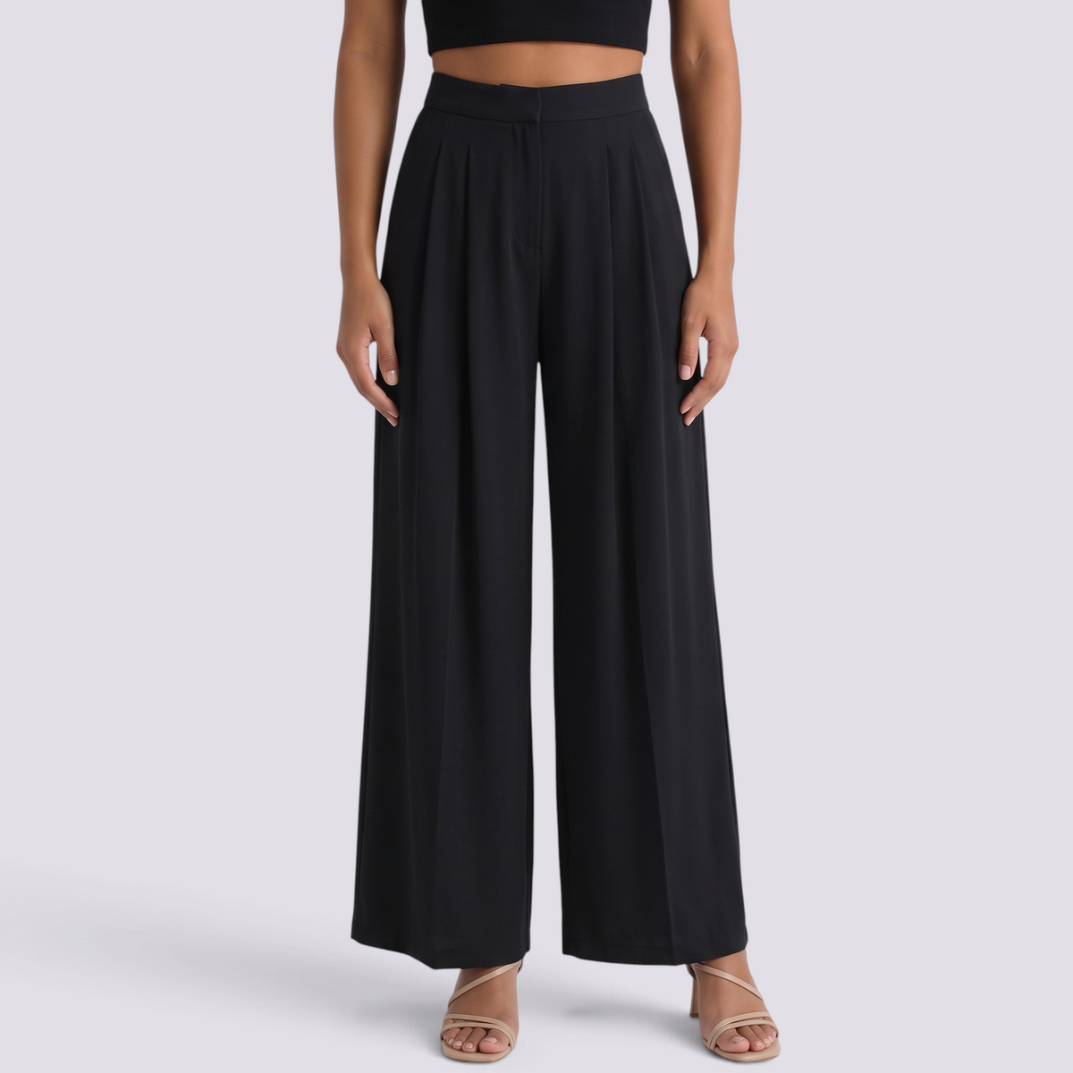 Essyro high-waisted black palazzo trousers with wide legs and front pleats worn with a black crop top
