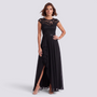 Essyro black lace high-waisted A-line maxi dress with a ruffled side slit worn by a woman on a grey background