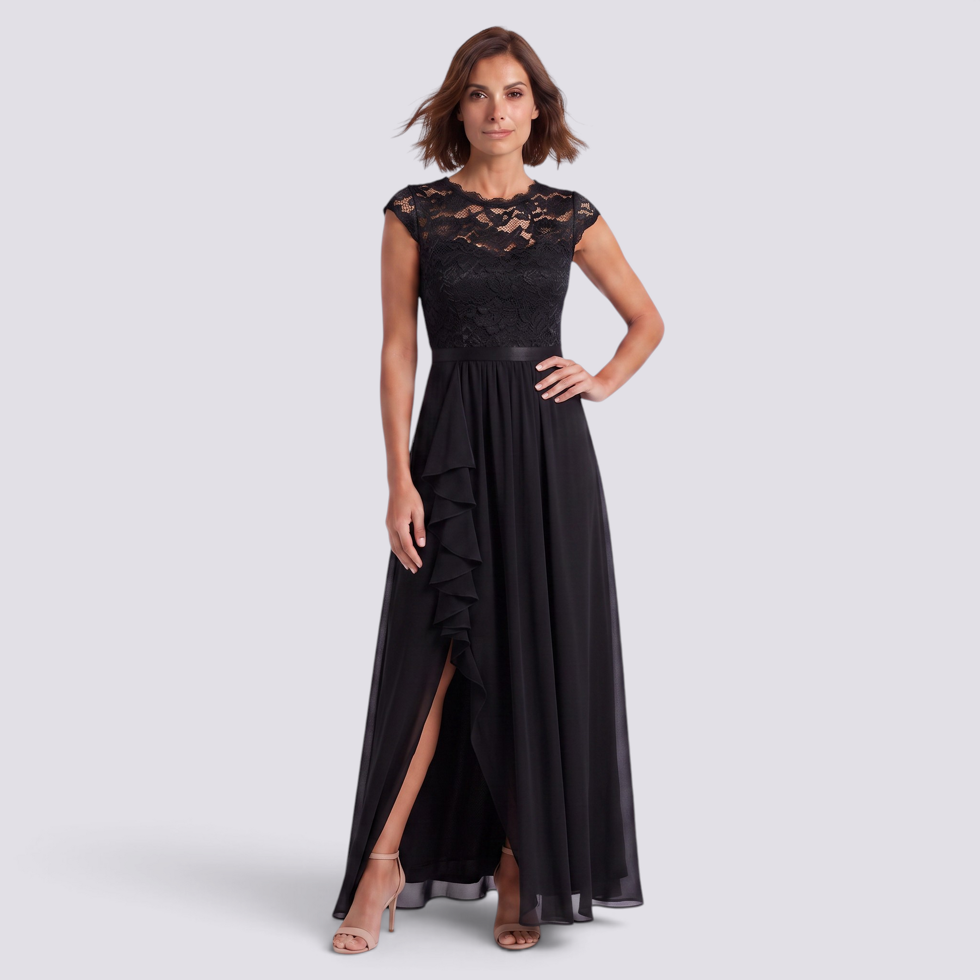Essyro black lace high-waisted A-line maxi dress with a ruffled side slit worn by a woman on a grey background