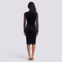 Back view of Essyro black midi sheath dress with long lace sleeves and scalloped hem on a model