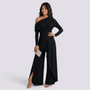 Essyro black one-shoulder jumpsuit with long draped sleeve and wide-leg trousers with front slit on a model