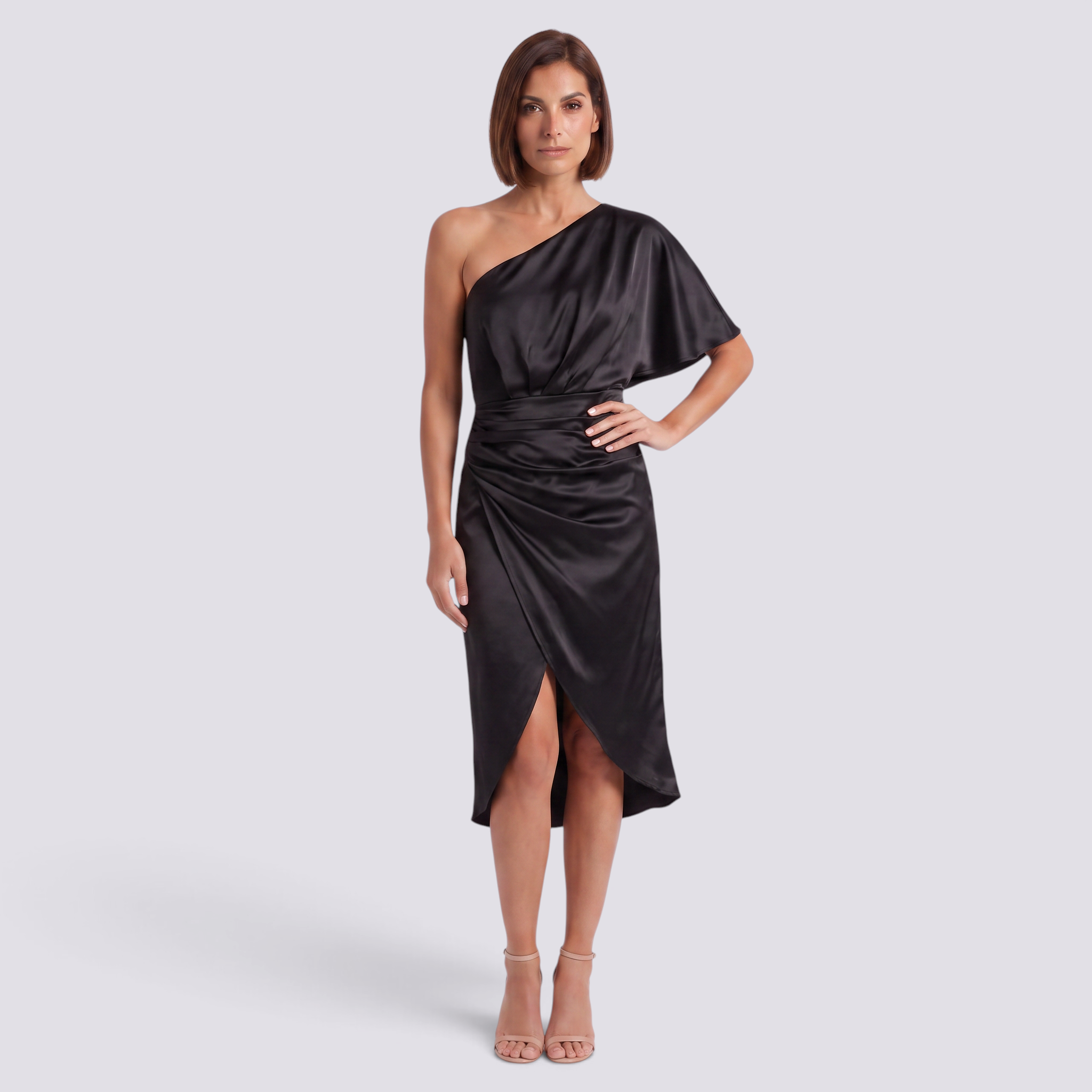 Essyro black one-shoulder satin party dress with asymmetrical hem worn by a woman on a neutral background