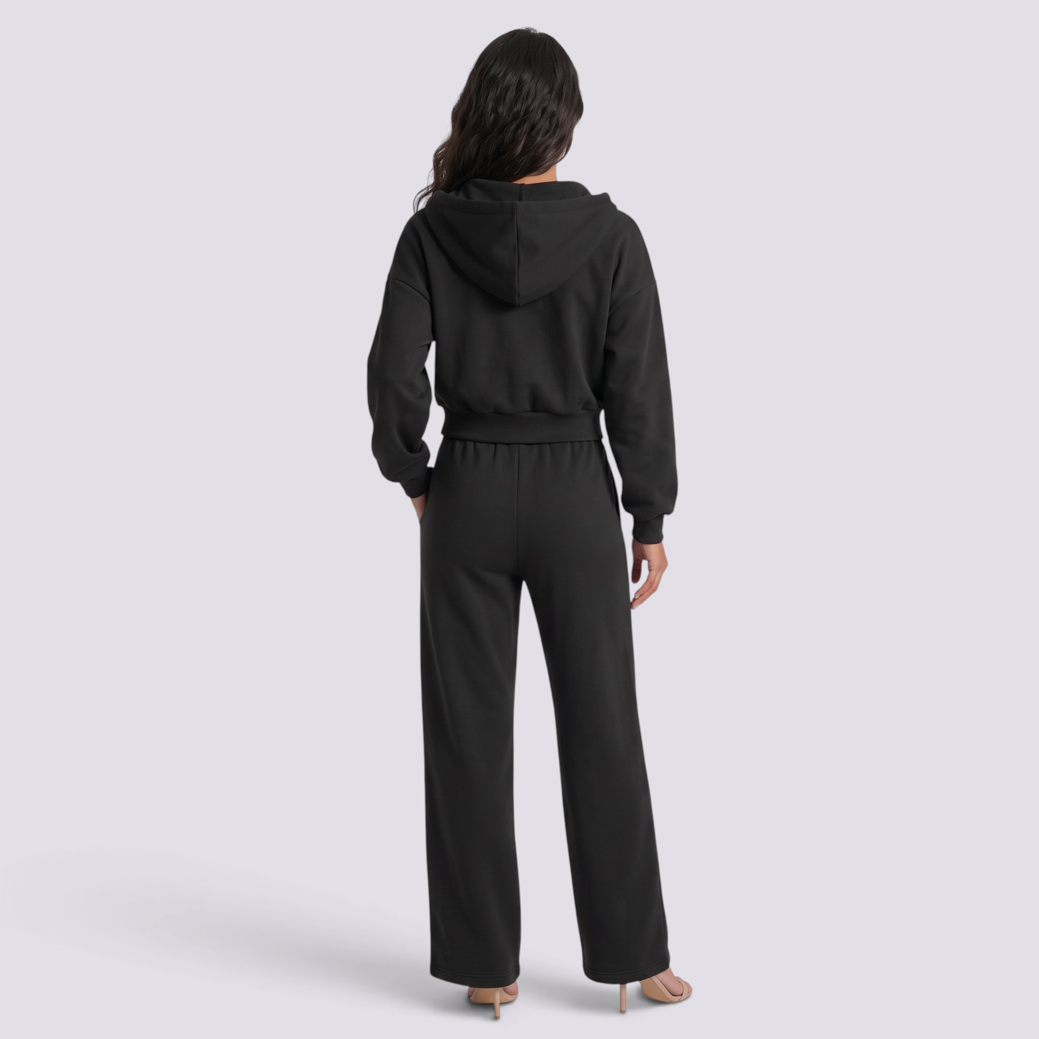 Essyro black oversized hoodie and wide-leg trousers set worn by a woman, back view showing a relaxed fit.