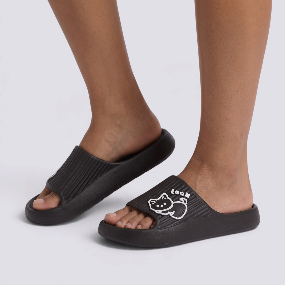 Essyro black platform slide sandals with a ribbed strap and a cute white embossed cat detail with the word look.