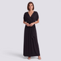 Essyro elegant black plus size maxi dress with a wrap-style bodice and flowing skirt worn by a woman