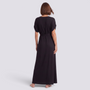 Essyro plus size black maxi dress with short sleeves and a flowing silhouette, shown from the back on a model.