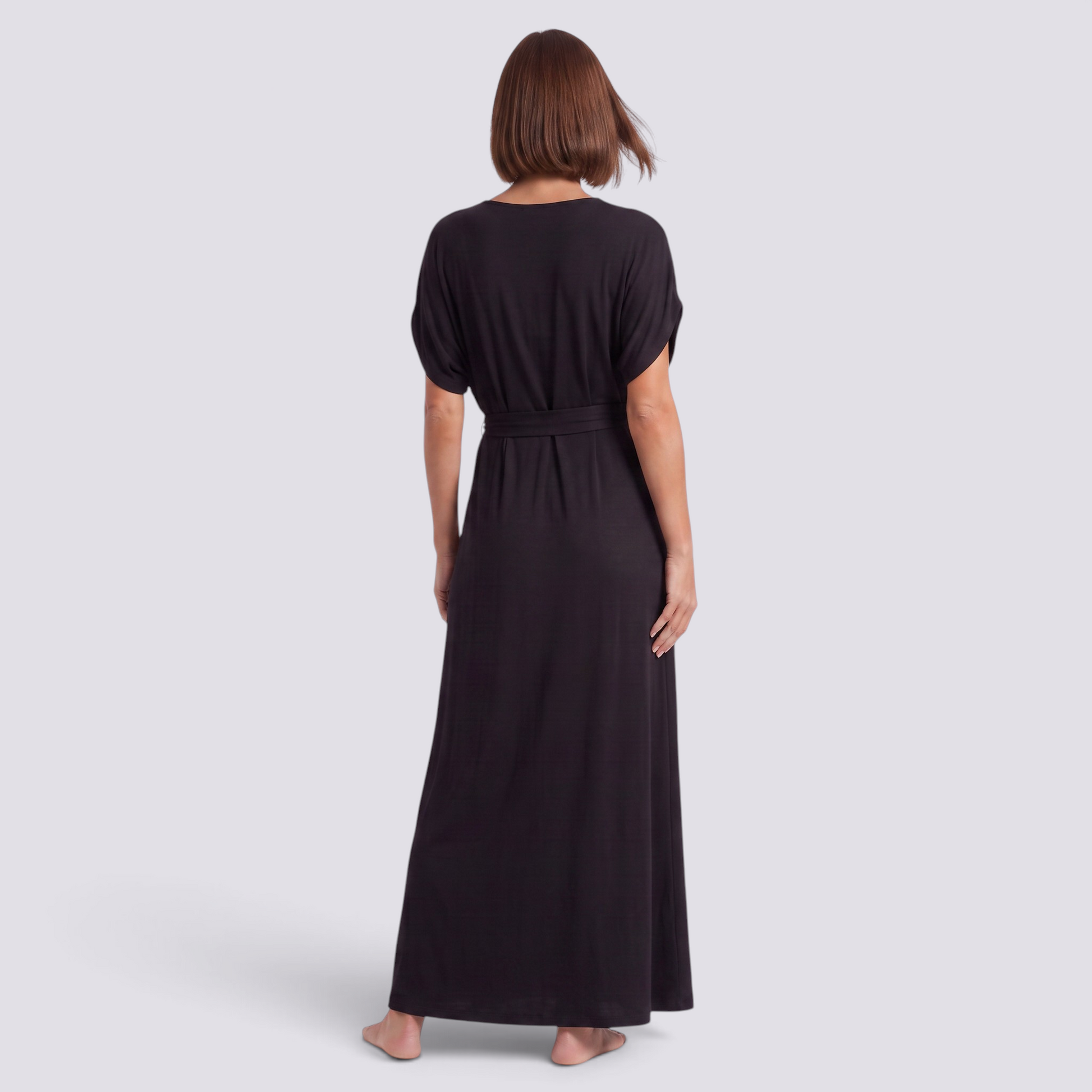 Essyro plus size black maxi dress with short sleeves and a flowing silhouette, shown from the back on a model.