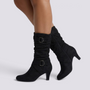 Essyro black slouch boots with mid-curved heels, decorative buckled straps, and soft faux suede finish.