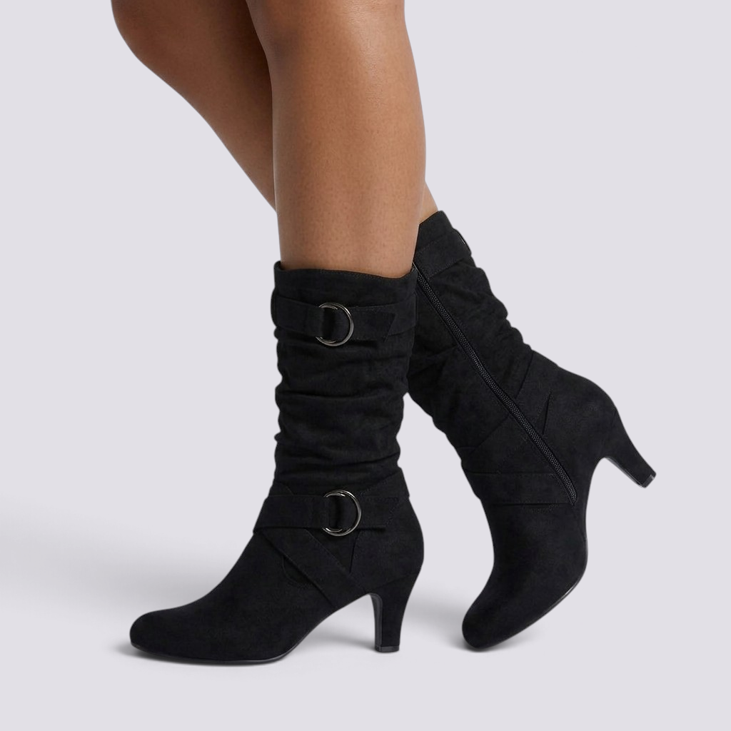 Essyro black slouch boots with mid-curved heels, decorative buckled straps, and soft faux suede finish.