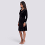 Essyro black velvet short dress with long sleeves and draped cowl neckline worn by a model in profile view