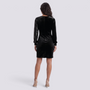 Essyro black velvet party dress with long sequined sleeves and a fitted silhouette, shown from the back.
